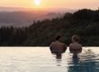 A couple in an infinity pool at RAKxa resort at Catelfalfi in Tuscany.