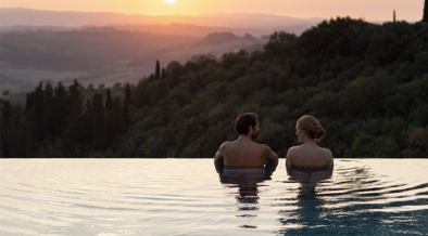 A couple in an infinity pool at RAKxa resort at Catelfalfi in Tuscany.