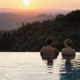 A couple in an infinity pool at RAKxa resort at Catelfalfi in Tuscany.