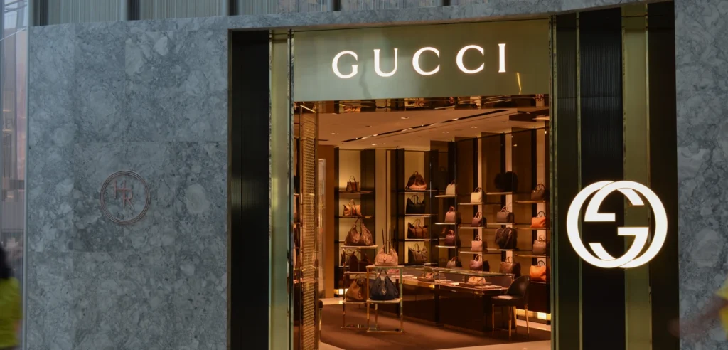 Gucci boutique entrance at Yorkdale Mall, with illuminated Gucci signage and handbags displayed inside.