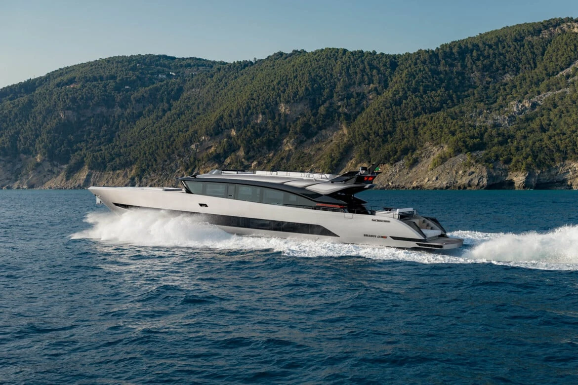 BRABUS AB110 performance yacht cruising at speed, showing its white-and-black hull, red accents and roof spoiler.