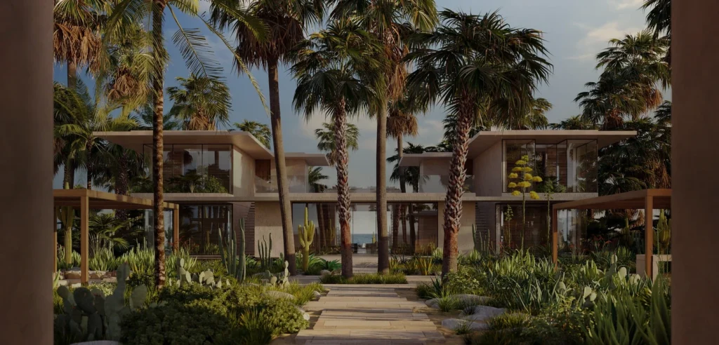 Amanvari resort buildings framed by palm trees and desert landscaping in Baja California Sur, Mexico.