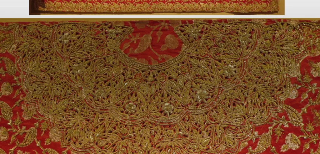 Gold zardozi embroidery on a red 20th-century wedding textile from Delhi, India.