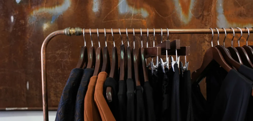 Dark and brown garments hanging in a boutique, representing clothing inventory generally.