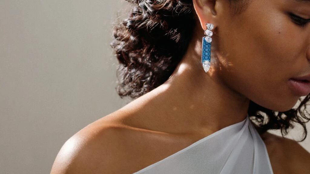 A blue titanium drop earring set with pear-shaped diamonds and sapphires.